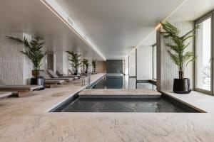 a lobby with a pool in the middle of a building at Bayline X in Armação de Pêra