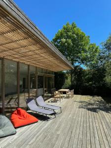 a wooden deck with two chairs and a table at Modern Summer House Close To Sea On Samsø in Kolby Kås