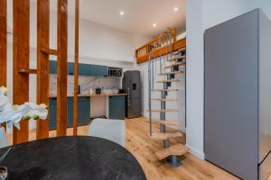 Modern Stay Unique Berlin في برلين: مطبخ وغرفة طعام مع درج حلزوني في المنزل