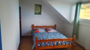 a small bed in a room with a staircase at Le Tranquillou in La Plaine des Cafres