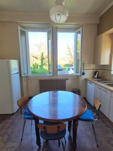 a kitchen with a table and chairs and a window at Au Moulin de Gary in Saint-Laurent-les-Tours