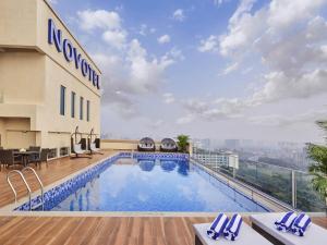 a pool on the roof of a hotel at Novotel Mumbai International Airport in Mumbai