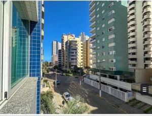 a view of a city street with tall buildings at Aproveitando o Sol e o Mar de Torres in Torres