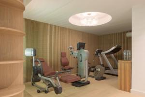 a gym with several exercise equipment in a room at Candia Lux in Heraklio