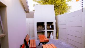 a patio with two benches and a fireplace at DC Guest House in Avondale
