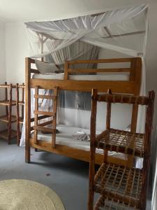 a couple of bunk beds in a room at Mambo Leo Hostel in Paje