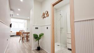 a bathroom with a shower and a potted plant at Apartamentos FLORIDA in Valladolid +100 photos