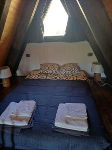 a bed in a tent with two lamps and two pillows at A frame Alba Iulia in Alba Iulia +18 photos
