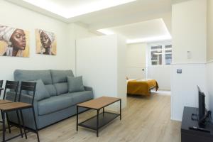 a living room with a couch and a table at Apartamentos FLORIDA in Valladolid