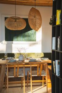 a dining room with a table with chairs and lights at Chalet Paseka in Pec pod Sněžkou