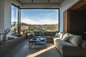 a living room with a couch and a large window at Chalet Paseka in Pec pod Sněžkou