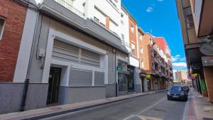 a car driving down a city street with buildings at Apartamentos FLORIDA in Valladolid