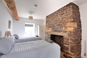 En eller flere senge i et værelse på Finest Retreats - Brecon House