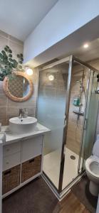 a bathroom with a shower and a sink and a toilet at L'Espadon in Luc-sur-Mer