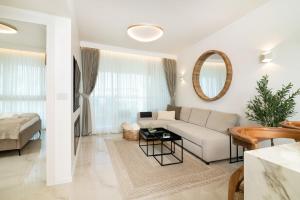 a living room with a couch and a table at Rose Suite in Caesarea +29 photos