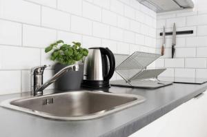 a kitchen sink with a coffee maker and a plant at Tott vacation homes in Åre +143 photos