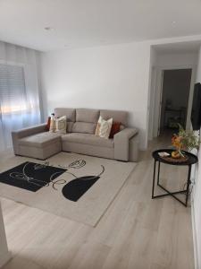un salon avec un canapé et une table dans l'établissement Morden Spacious Apartment, à Entroncamento