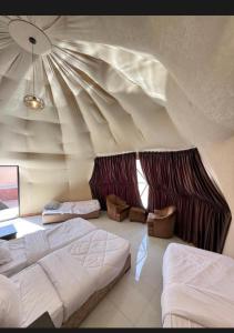 a room with two beds and a ceiling at Rum Desert Silence Camp in Wadi Rum