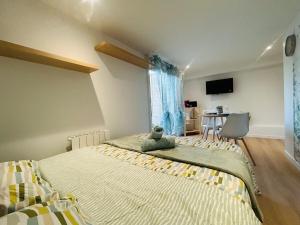 ein Schlafzimmer mit einem Bett, auf dem ein Stofftier liegt in der Unterkunft Casa Nature in Les Ponts-de-Cé