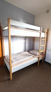 two bunk beds in a room with a ladder at Gruppenunterkunft am Waldsee in Krefeld +9 photos