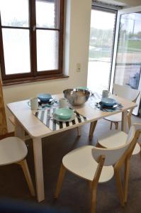 a table with plates and bowls on top of it at Gruppenunterkunft am Waldsee in Krefeld
