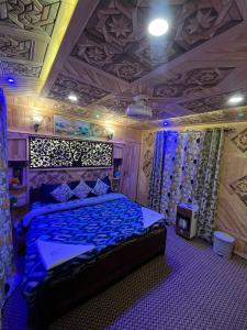 a bedroom with a bed with a blue comforter at Houseboat Quebec in Srinagar