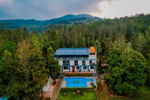 an aerial view of a house with a swimming pool at The Nature's Nest in Attigundi