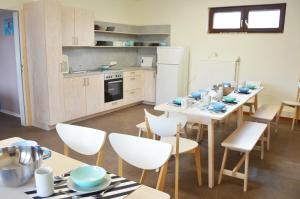 a kitchen with a table and chairs in a kitchen at Gruppenunterkunft am Waldsee in Krefeld