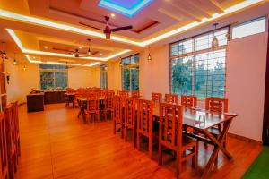 a dining room with a table and chairs at The Nature's Nest in Attigundi