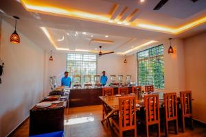 a restaurant with a table and chairs in a room at The Nature's Nest in Attigundi +54 photos