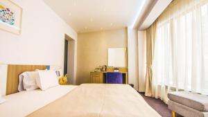 a hotel room with a bed and a window at Parliament Square in Bucharest