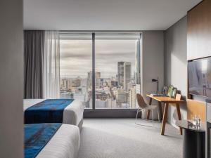 a hotel room with a view of a city at The Adnate Perth - Art Series in Perth
