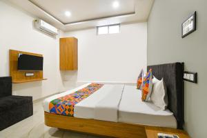 a bedroom with a bed and a tv in it at FabHotel Paradise Inn in Indore +23 photos