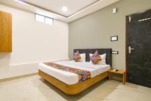 a bedroom with a bed in a room at FabHotel Paradise Inn in Indore