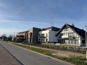 een zwart-wit gebouw aan de straatkant bij Casa del Lago - Ferienwohnungen am Dümmer See in Lembruch