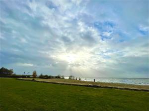 een persoon op een strand bij het water bij Casa del Lago - Ferienwohnungen am Dümmer See in Lembruch