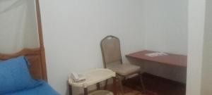 a room with a desk and a table with a phone at Agenda Namasuba in Kampala