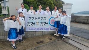 a group of women standing in front of a sign at Guest House Gamigami in Onomichi