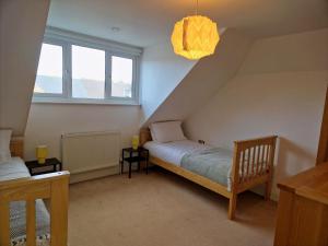 a small room with a bed and a window at Broadstairs Hideaway W Parking and Mins to Beach in Broadstairs +18 photos
