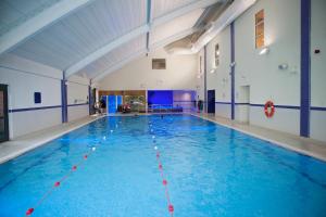 uma grande piscina com água azul num edifício em The Bannatyne Spa Hotel em Hastings