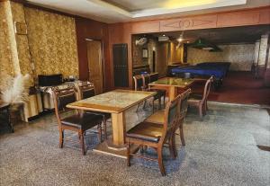 a dining room with a table and chairs and a bed at Million Mansion in Bangkok