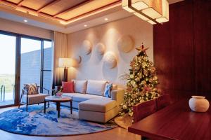 a living room with a christmas tree and a couch at Anantara Mina Ras Al Khaimah Resort in Ras al Khaimah