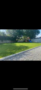 a view of a park with a playground at Shangri - La Spacious Family Townhouse in Killarney