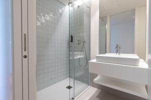 a bathroom with a sink and a glass shower at Bayline XV in Armação de Pêra +36 photos
