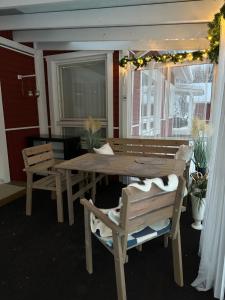 a dining room table and chairs with lights and a window at Havuille Lodge in Rovaniemi