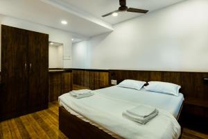 a bedroom with a bed with towels on it at CozyKey Rooms Bandra in Mumbai