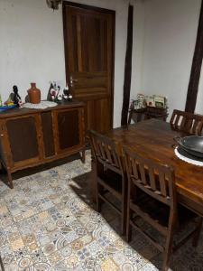a dining room with a wooden table and chairs at Chácara do Conde in Mangaratiba +53 photos