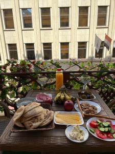 a table with a bunch of food on it at Lovely Rivera Room with Breakfast in Cairo