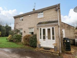 a brick house with a white door at Lair Close House in Harrogate