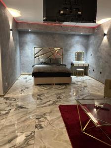 a bedroom with a bed and a table in it at Le Palais Du Khalif in Fabrègues